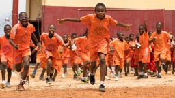 Line of school children running and laughing